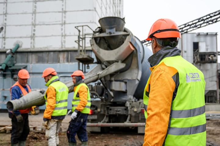 Бригада будівельників і автобетонозмішувач на об'єкті